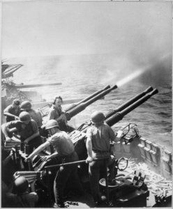 Task Force 58 raid on Japan. 40mm guns firing aboard USS HORNET on 16 February 1945, as the carrier's planes were... - NARA - 520746