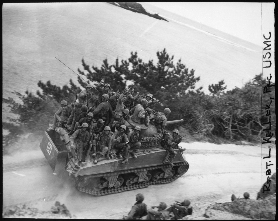 Tank-borne infantry moving up to take the town of Ghuta before the Japanese can occupy it. The men are members of the... - NARA - 532549