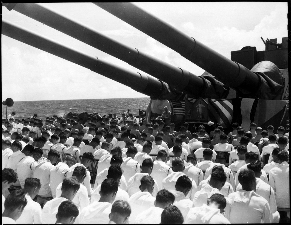 The crew of the USS SOUTH DAKOTA stands with bowed heads, while Chaplain N. D. Lindner reads the benediction held in... - NARA - 520649
