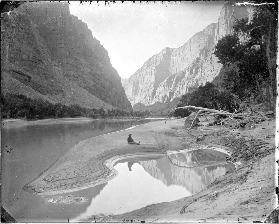 The heart of Lodore, Green River-F.S. Dellenbaugh is seated and reflected in the water. Beaman photo - NARA - 517793