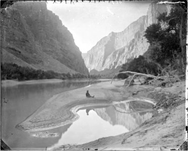 The heart of Lodore, Green River-F.S. Dellenbaugh is seated and reflected in the water. Beaman photo - NARA - 517793