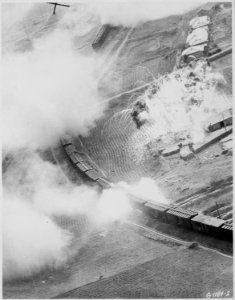 The tank of napalm dropped by Fifth Air Force B-26 Invader light bombers of the 452nd Bomb Wing (light) on this Red... - NARA - 542187 photo