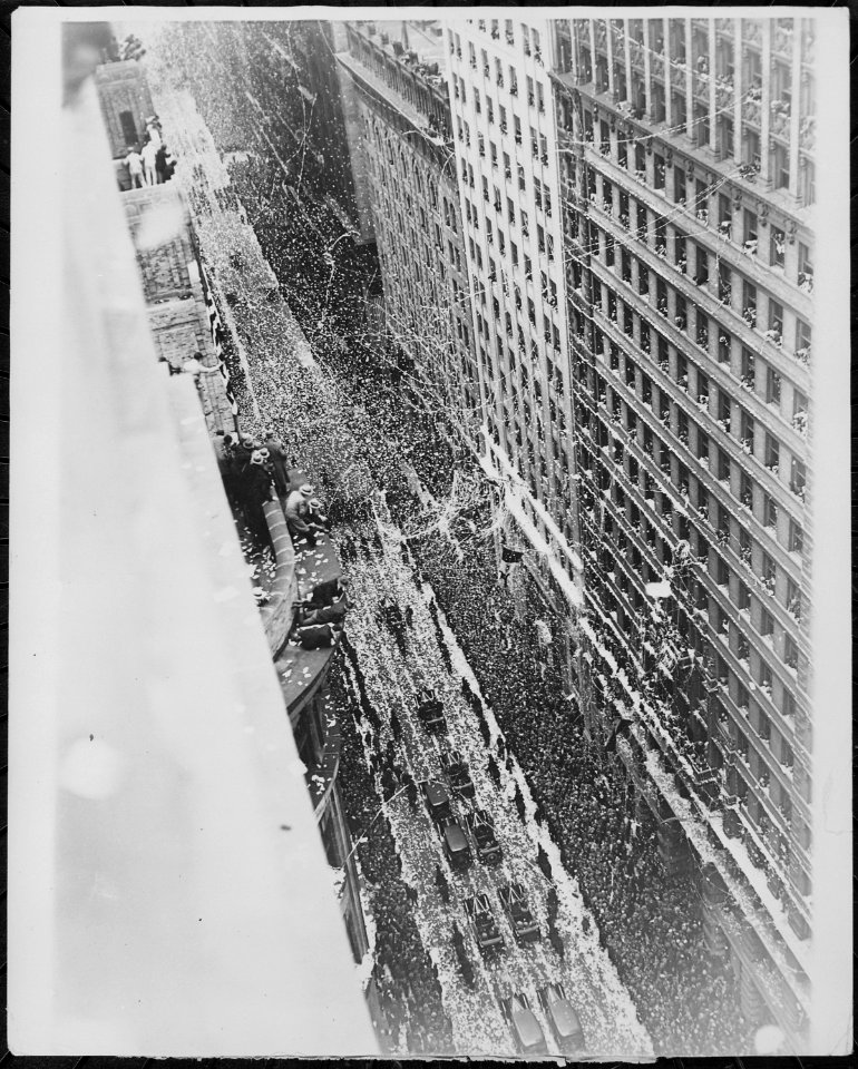 Ticker tape and confetti floating onto the motorcade carrying the crew of the Bremen, and the crowds assembled to greet - NARA - 541910