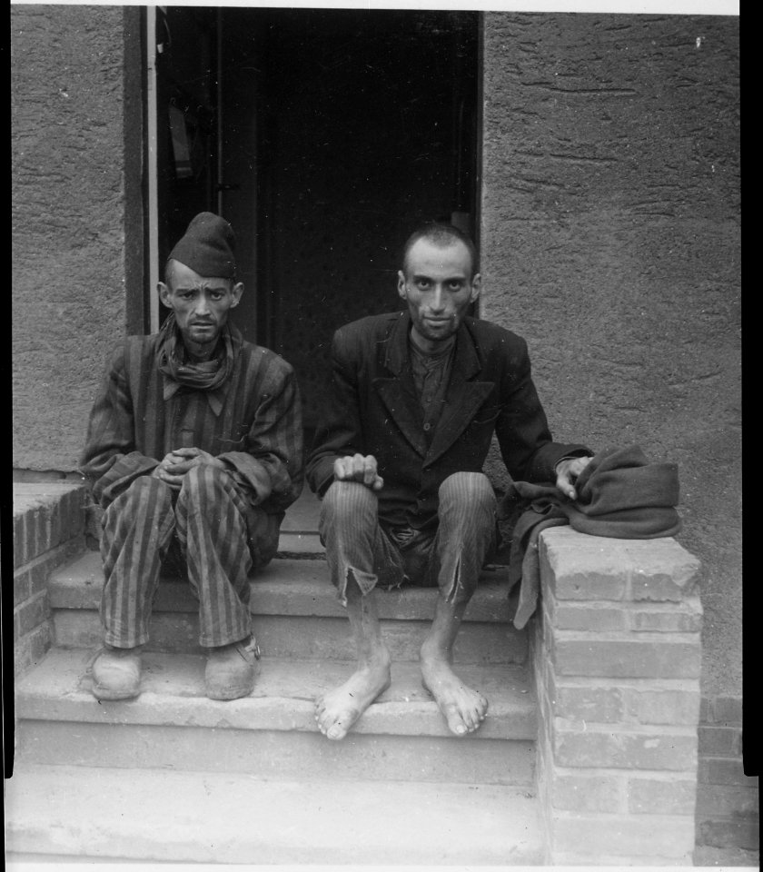 These two staring, emaciated men are liberated inmates of Lager Nordhausen, a Gestapo concentration camp. The camp... - NARA - 531258