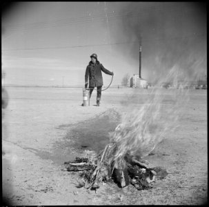 Topaz, Utah. A demonstration of fire fighting with a stirrup pump is put on by an evacuee member of . . . - NARA - 537014