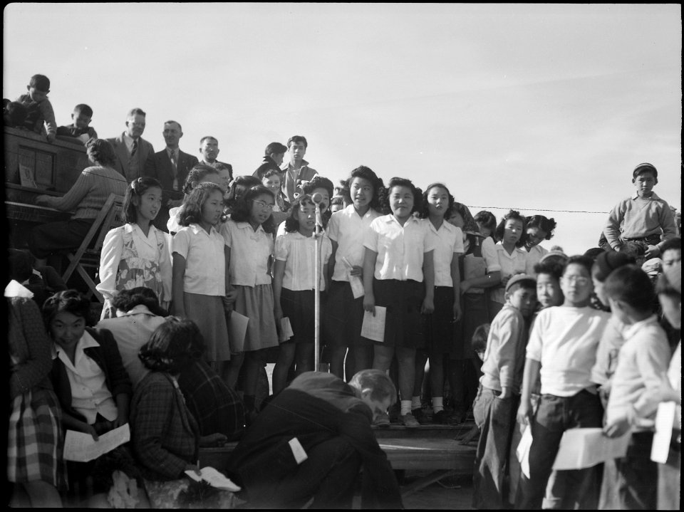 Topaz, Utah. Girls' grade school chorus render a song during ceremonies opening the football game b . . . - NARA - 539517
