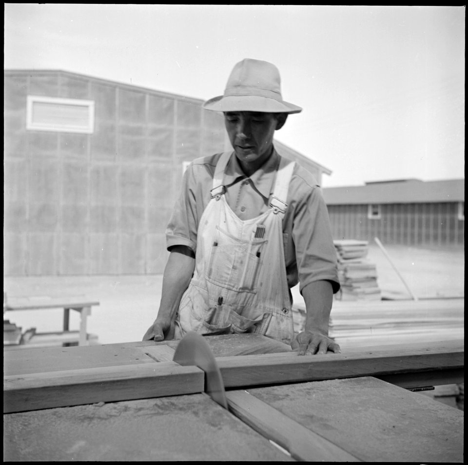 Topaz, Utah. Japanese resident at the Topaz Center operating the power driven saw in preparing stan . . . - NARA - 538713