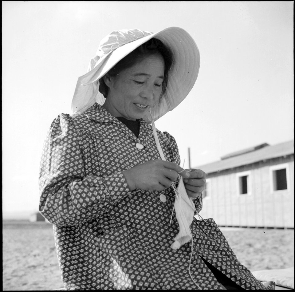 Topaz, Utah. Knitting warm woolen clothing for her children against the coming winter, this Japanes . . . - NARA - 538698