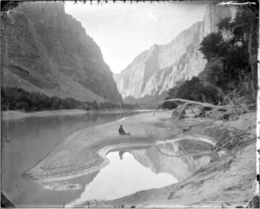 The heart of Lodore, Green River-F.S. Dellenbaugh is seated and reflected in the water. Beaman photo - NARA - 517793