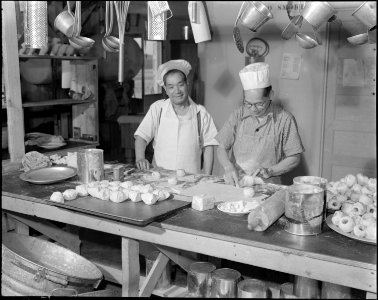 Topaz, Utah. Chefs of Japanese ancestry making apple turnovers for the evening meal at this relocat . . . - NARA - 538671