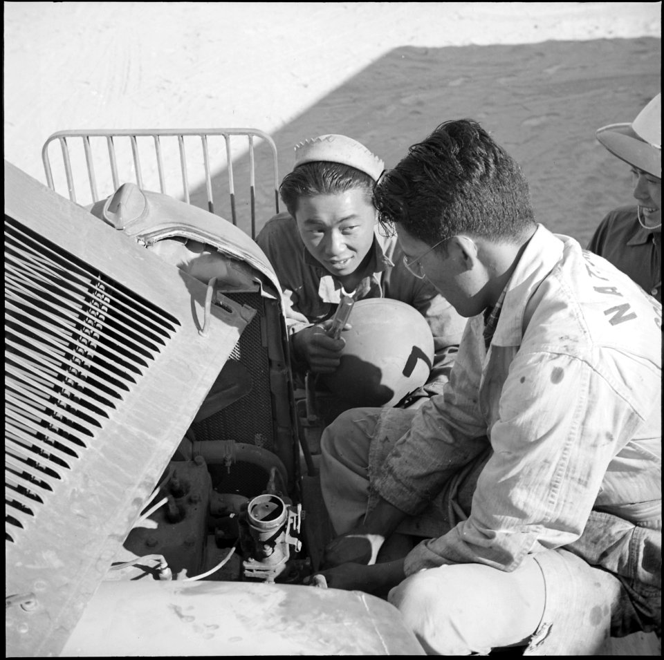 Topaz, Utah. Keeping well warm motor equipment running is a problem confronting these two Nisei vol . . . - NARA - 538699