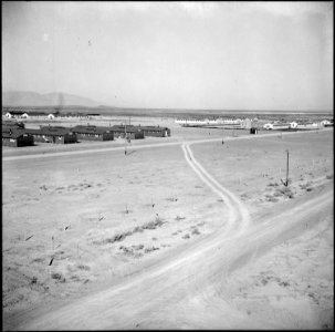 Topaz, Utah. One corner of the Topaz Relocation Center. White buildings at the right are the milit . . . - NARA - 538680