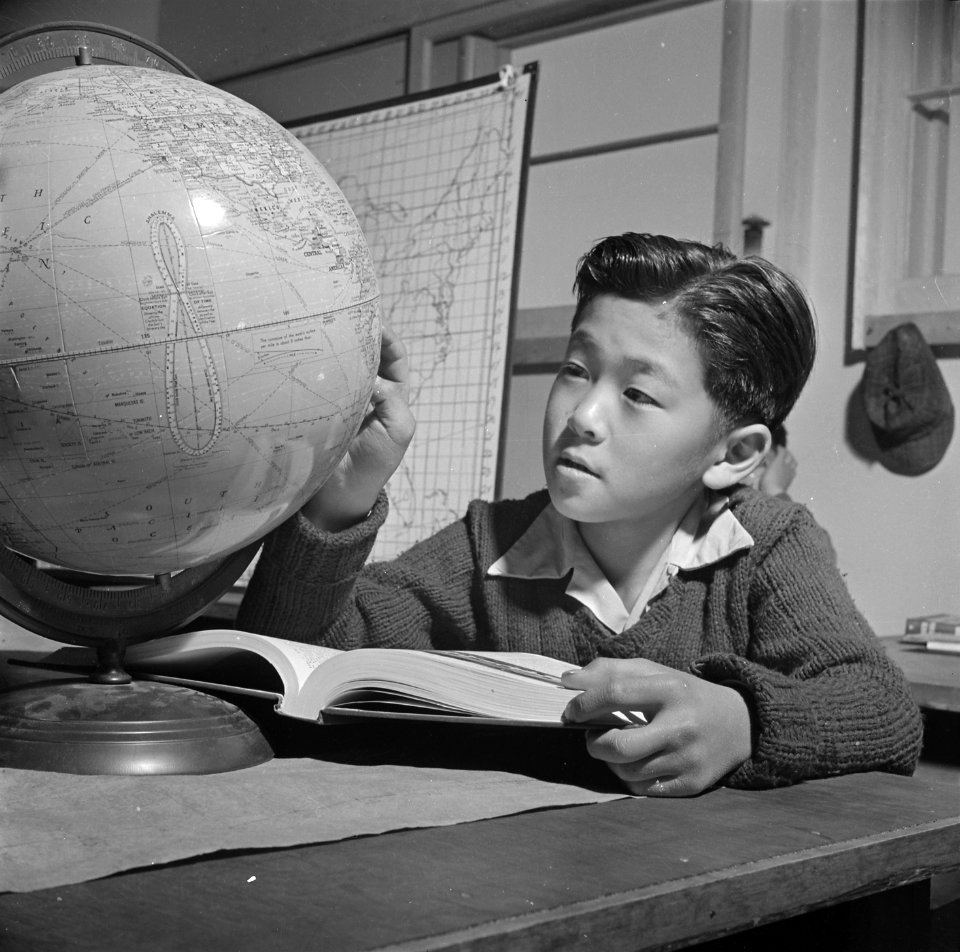 Topaz, Utah. A globe is used by this pupil in the high first grade, to assist in his geography lesson. - NARA - 536993