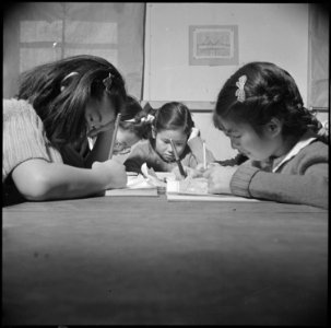 Topaz, Utah. Pupils of the high first grade are shown busily at work on their geography lessons. - NARA - 536992 photo