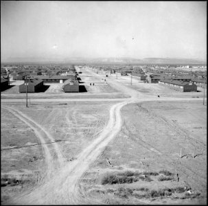 Topaz, Utah. Locking down a main thoroughfare at the Topaz Relocation Center. - NARA - 538677