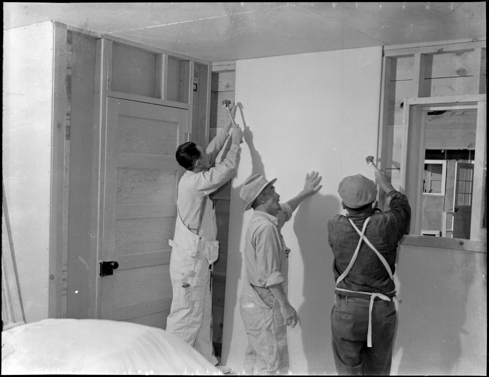 Topaz, Utah. Volunteer carpenters placing the interior lining in one of the barracks at the Topaz C . . . - NARA - 538673