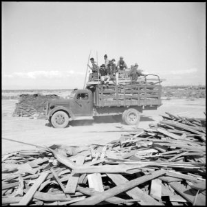 Topaz, Utah. Off with a load of scrap from the contractor's pile. The volunteer workers riding on . . . - NARA - 538721