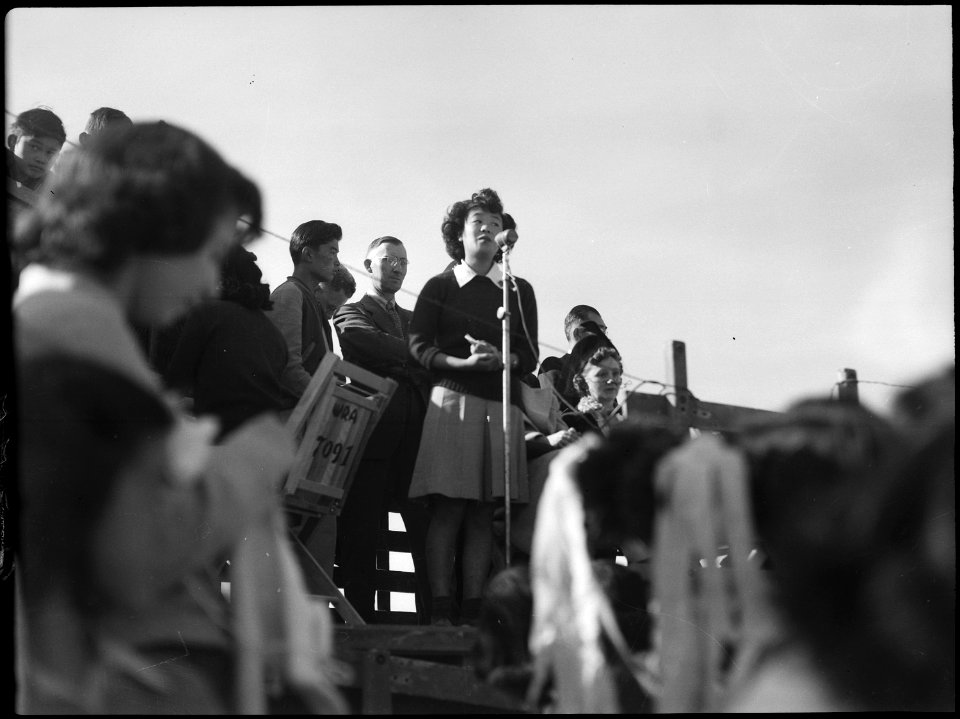 Topaz, Utah. Yo Ikeda raises her beautiful voice during ceremonies which opened the football game be . . . - NARA - 539512