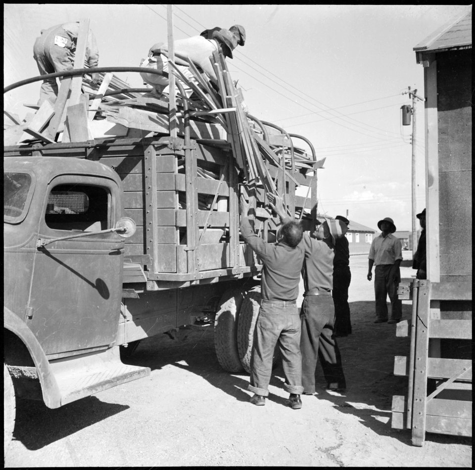 Topaz, Utah. Volunteer workers delivering scrap wood to be used as kindling at barracks at the Topa . . . - NARA - 538704