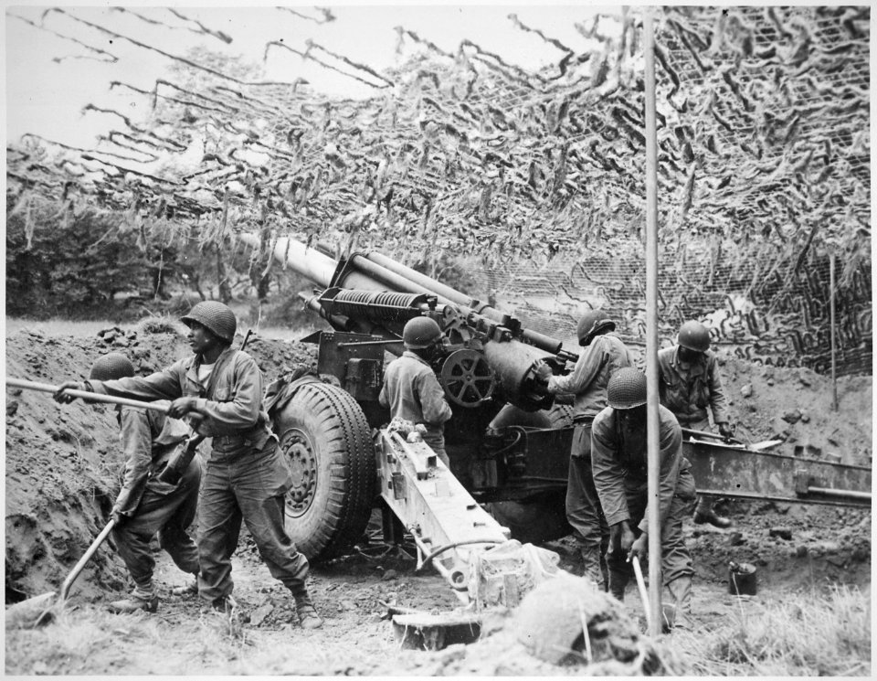 Troops of a field artillery battery emplace a 155mm howitzer in France. They have been following the advance of the ... - NARA - 531198