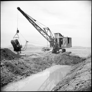 Tule Lake Relocation Center, Newell, California. A dredge is used to dig a drainage ditch on the fa . . . - NARA - 538248
