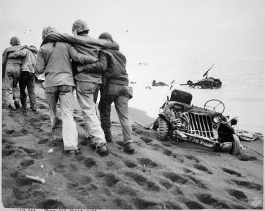 They did their part. Wounded Marines are helped to an aid station by Navy corpsmen and Marine walking wounded. Iwo... - NARA - 532362 photo