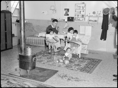 Tule Lake Relocation Center, Newell, California. An evacuee family spends a quiet evening in their . . . - NARA - 538444