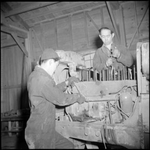 Tule Lake Relocation Center, Newell, California. An expert job of motor repairing is done on a heav . . . - NARA - 536730