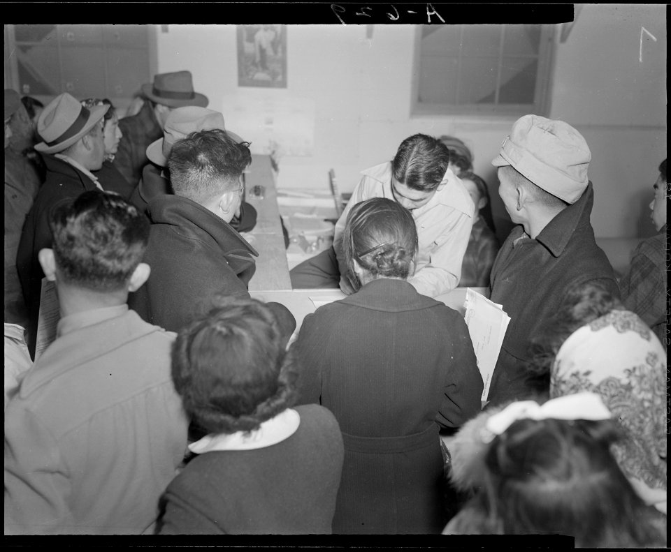 Tule Lake Relocation Center, Newell, California. Absentee voters of Japanese descent getting ballot . . . - NARA - 536515