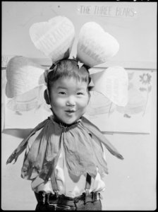 Tule Lake Relocation Center, Newell, California. Little Bobby wears a head dress which was part of . . . - NARA - 538342