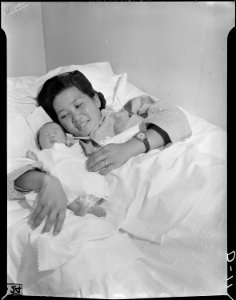 Tule Lake Relocation Center, Newell, California. Proud Mrs. Kumiko Noda, 23, evacuee from Florin, C . . . - NARA - 538210
