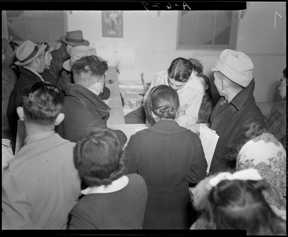 Tule Lake Relocation Center, Newell, California. Absentee voters of Japanese descent getting ballot . . . - NARA - 536515
