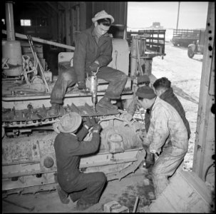 Tule Lake Relocation Center, Newell, California. The treads on a Caterpillar tractor are repaired b . . . - NARA - 536731 photo