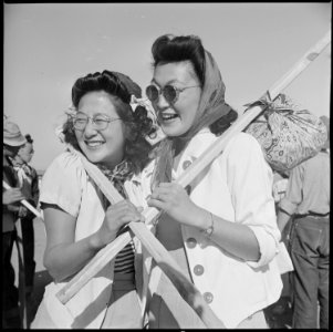 Tule Lake Relocation Center, Newell, California. Two pretty evacuees shouldered their lunch and hik . . . - NARA - 538394