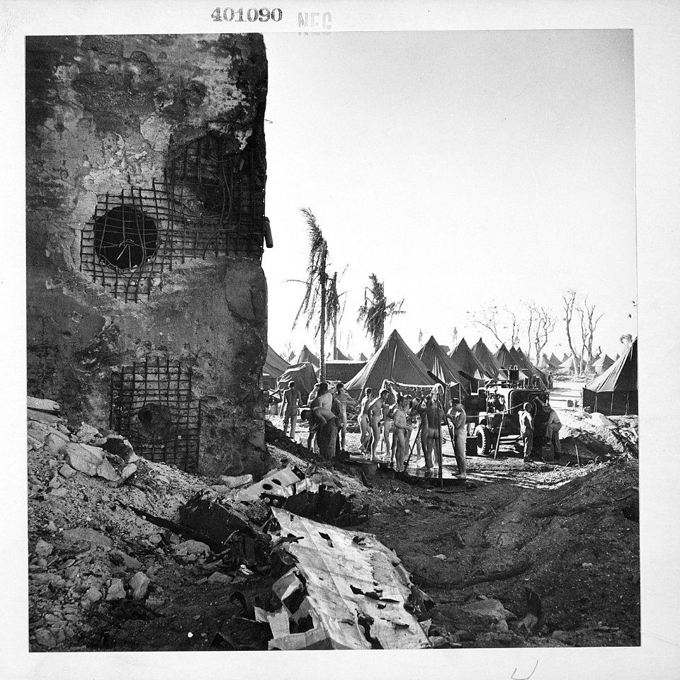 U.S. Marines catching a quick shower in hastily built showers on Namur Island. - NARA - 520721