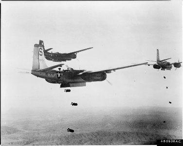 U.S. Air Force B-26 (Invader) light bombers release quarter ton demolition bombs in a strike over North Korea. The... - NARA - 542237