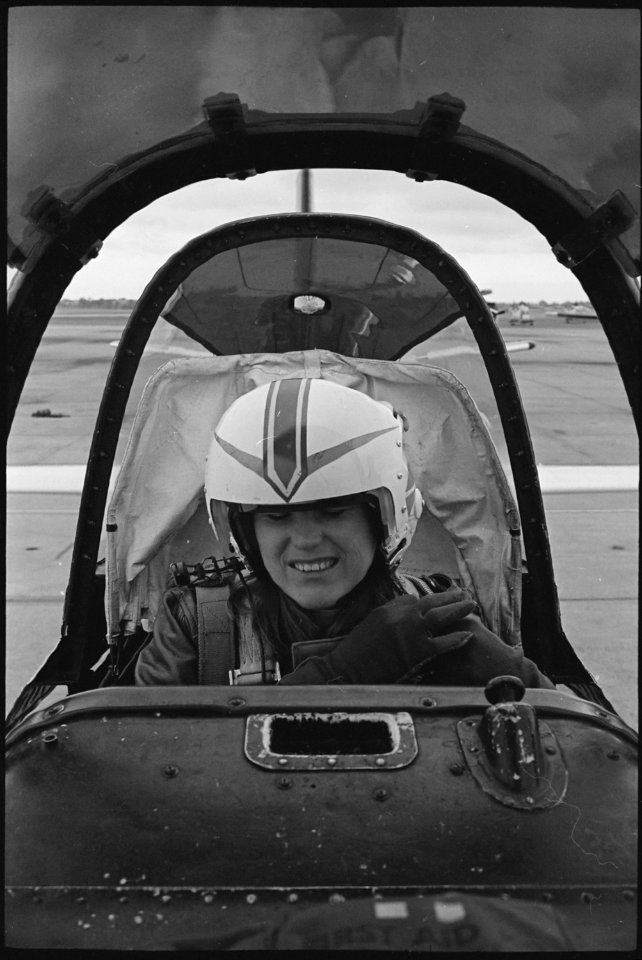 United States Naval Air Station, Norfolk, Virginia....Ens. Gloria Darnstaedt tucks her hair into her flight helmet as... - NARA - 558534