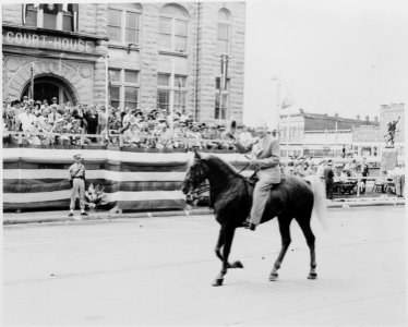 Unidentified man on horseback passing in front of the reviewing platform on which President Harry S. Truman is... - NARA - 199898