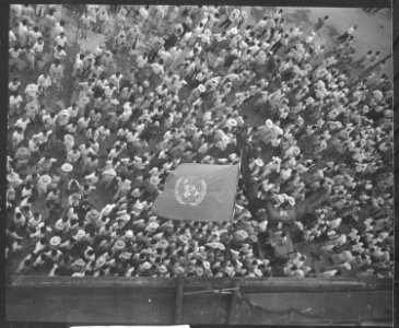 United Nations flag waves over crowd waiting to hear Dr. Syngman Rhee speak to the United Nations Council in Taegu... - NARA - 531365