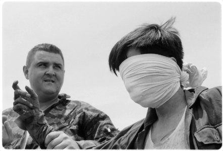 Van-Tuong, Vietnam....Staff Sergeant R.E. Steffy binds and blindfolds a Viet Cong who was taken prisoner. - NARA - 532433