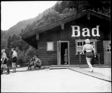 Verboten^ Men of 101st Airborne Division remember they can not fraternize as they watch a shapely fraulein swing up... - NARA - 531301 photo