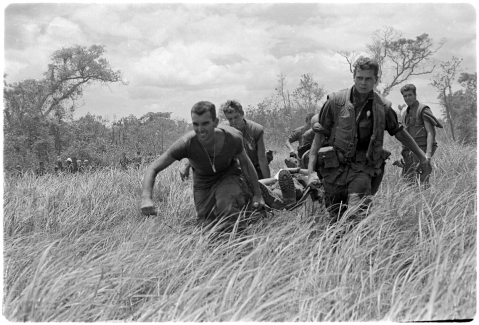 Vietnam. Medical Evacuation. Marines of Company E, 2nd Battalion, 9th Marines, while under heavy firefight with NVAs... - NARA - 532448