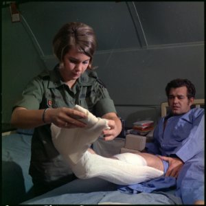 Vietnam. 1st Lt. Elaine H. Niggemann changes a surgical dressing for Mr. James J. Torgelson at the 24th Evacuation... - NARA - 530630