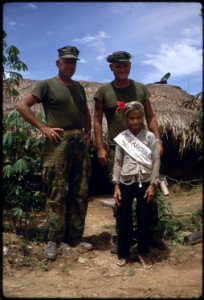 Vietnam....Sergeant Major Lewis E. Tuttle and Major O'Toole pose with an old woman in the Arizona Territory. The... - NARA - 532486