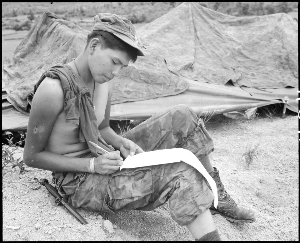 Vietnam....Private First Class Joseph Big Medicine Jr., a Cheyenne Indian, writes a letter to his family in the... - NARA - 532485