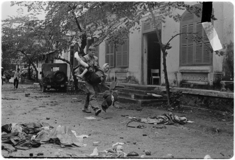Vietnam....A grenadier from the 3rd Platoon, Company 2nd H, 2nd Battalion, 5th Marines, carries a Vietnamese woman... - NARA - 532480