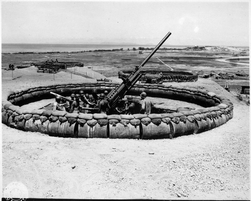 View of ^4 90mm Anti-aircraft artillery gun emplacement with crew in pit. D Battery, 98th Anti-aircraft artillery... - NARA - 531316