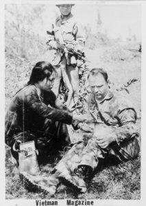 United States Air Force Captain Wilmer N. Grubb is given first aid while being guarded by his captors in North Vietnam. - NARA - 542311