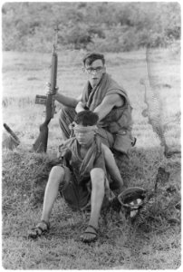 Vietnam....Corporal M.R. Carter guards an NVA soldier he captured during a ground movement ten miles northeast of An... - NARA - 532503