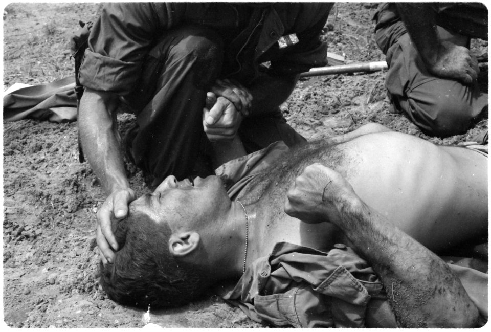Vietnam....A young Marine wounded by a Viet Cong booby trap is comforted by a fellow Marine. - NARA - 532502